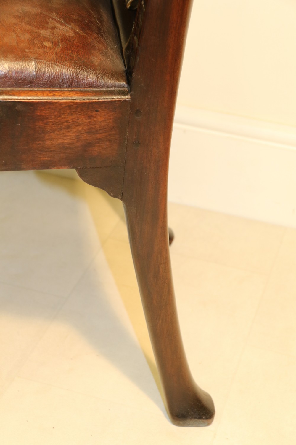 A late 19th-century Chippendale style mahogany armchair featuring carved eagle head terminals, a pierced back splat, brown leather seat, and cabriole legs with claw and ball feet. View XVII