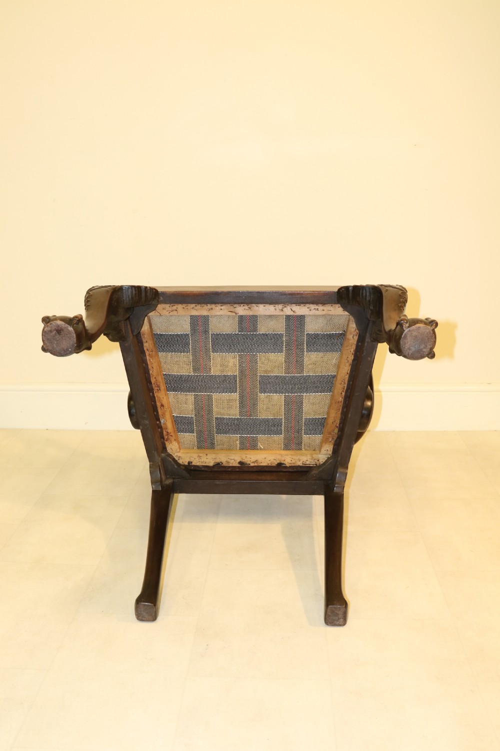 A late 19th-century Chippendale style mahogany armchair featuring carved eagle head terminals, a pierced back splat, brown leather seat, and cabriole legs with claw and ball feet. View XX