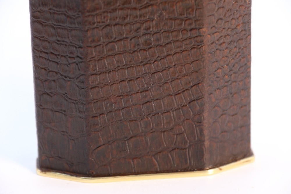 An Art Deco table lighter featuring a brown crocodile-embossed leather body with a solid brass base and upper lift-arm mechanism. View XII