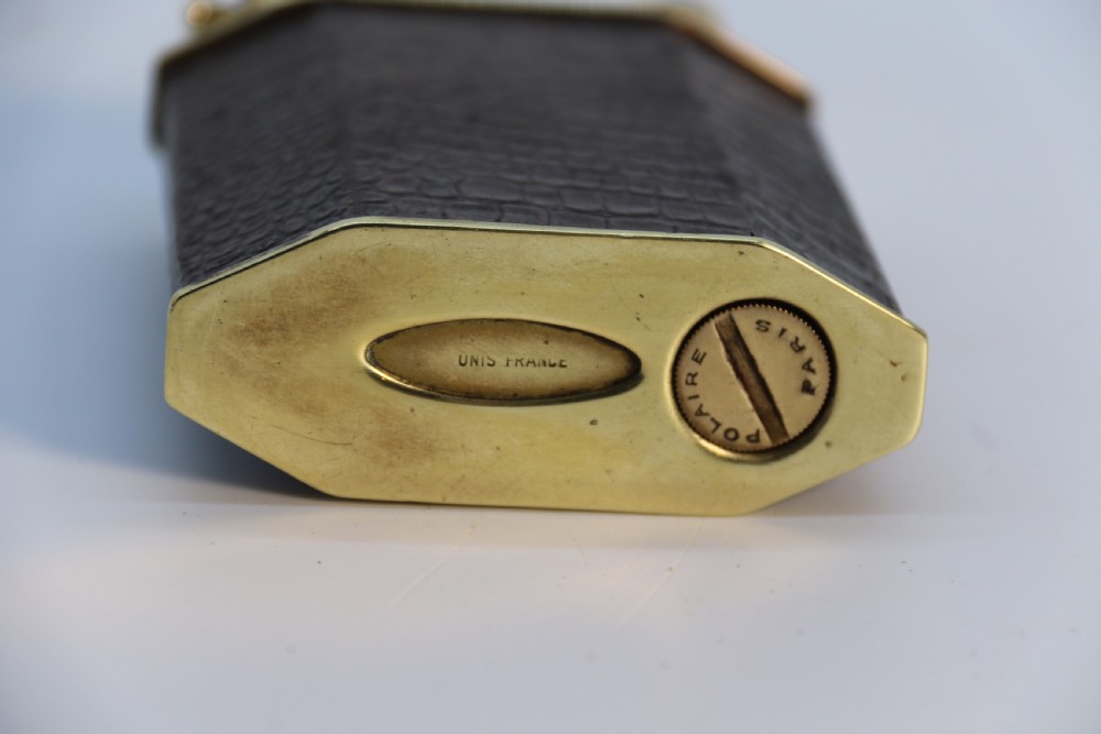 An Art Deco table lighter featuring a brown crocodile-embossed leather body with a solid brass base and upper lift-arm mechanism. View XIII