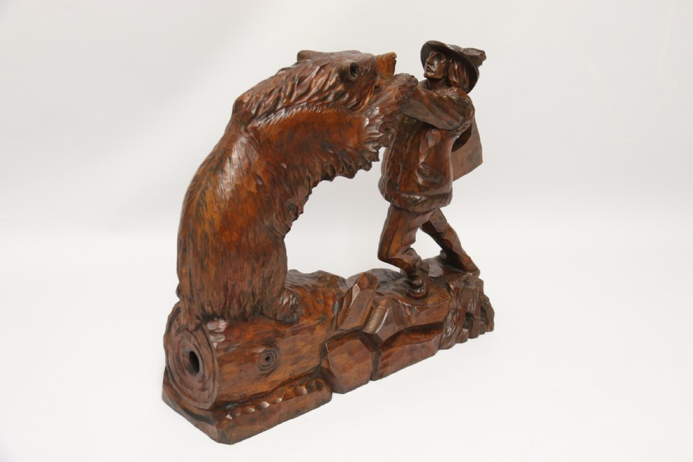 A late 19th-century carved wooden figure group depicting a huntsman battling a rearing bear on a log-form base. View VIII
