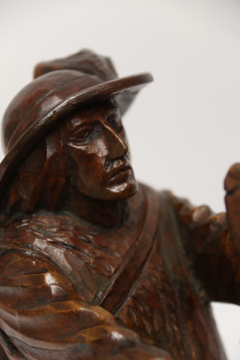 A late 19th-century carved wooden figure group depicting a huntsman battling a rearing bear on a log-form base. View X
