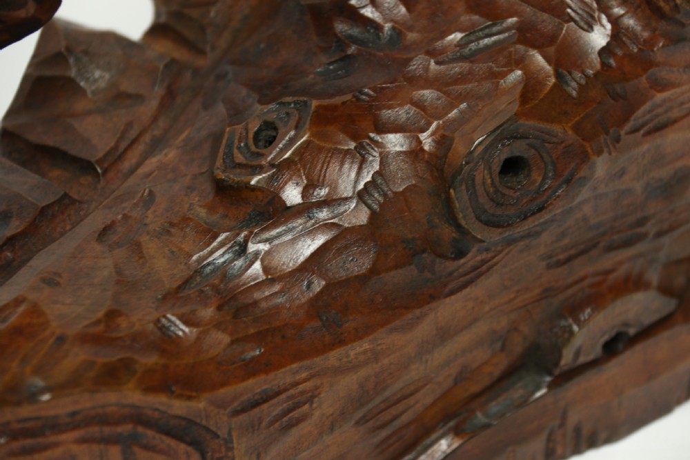 A late 19th-century carved wooden figure group depicting a huntsman battling a rearing bear on a log-form base. View XIII
