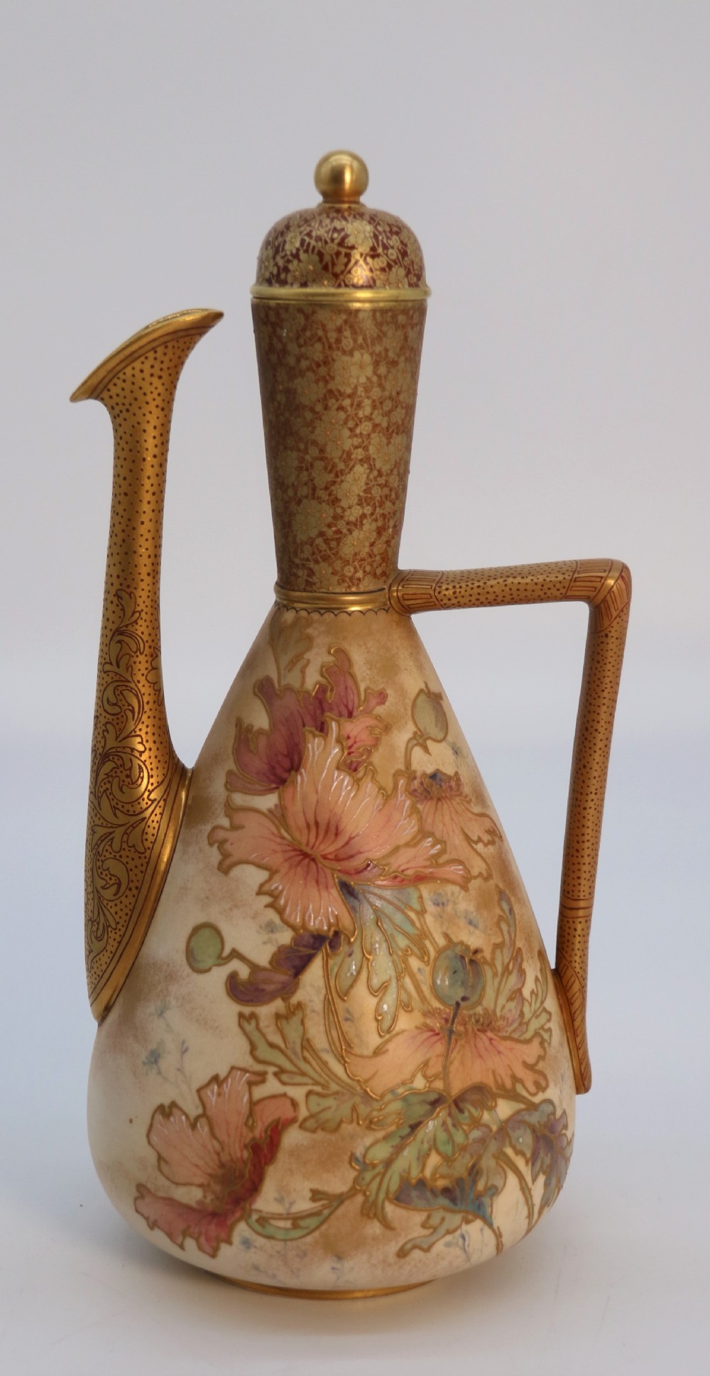 A late 19th-century Doulton Burslem ceramic ewer featuring hand-painted pink floral motifs, an elongated gilt spout, stippled gold handle, and matching stopper.