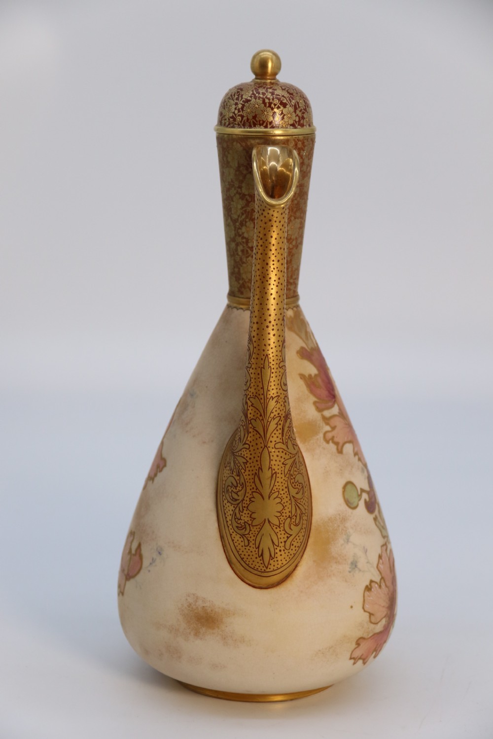 A late 19th-century Doulton Burslem ceramic ewer featuring hand-painted pink floral motifs, an elongated gilt spout, stippled gold handle, and matching stopper. View V