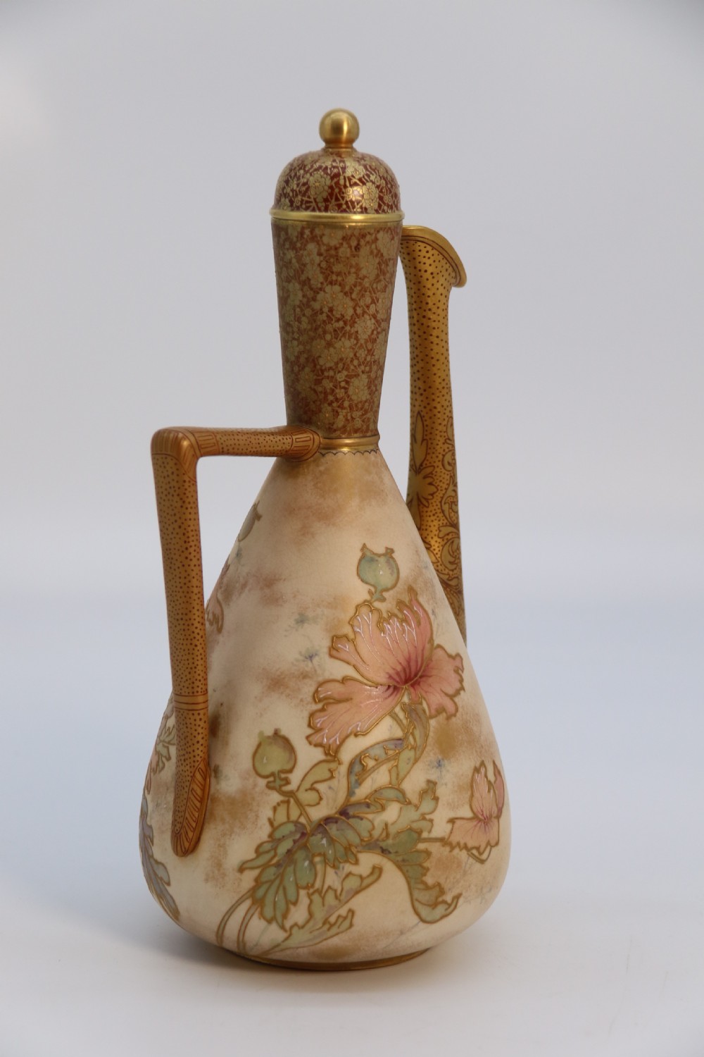 A late 19th-century Doulton Burslem ceramic ewer featuring hand-painted pink floral motifs, an elongated gilt spout, stippled gold handle, and matching stopper. View VI