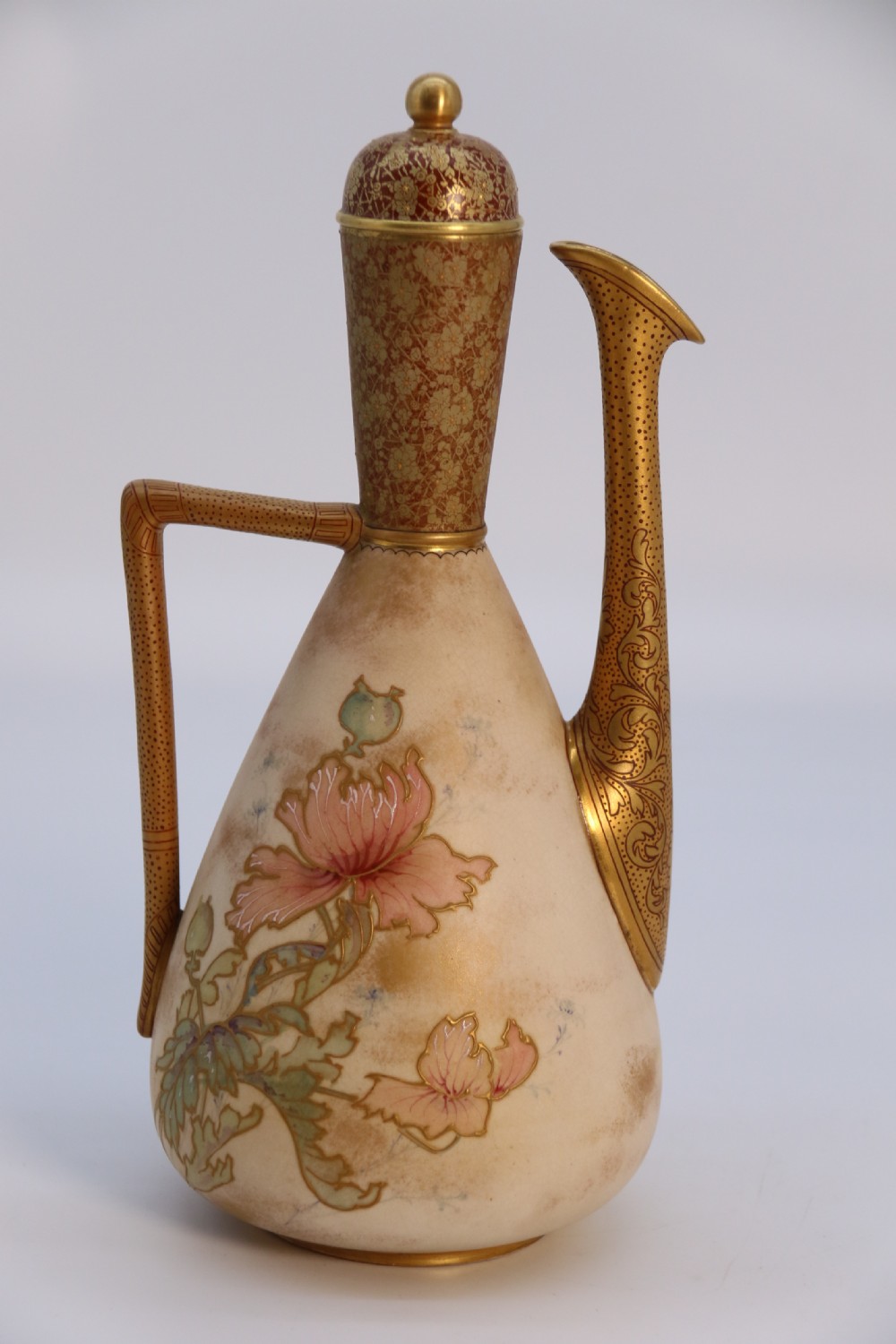 A late 19th-century Doulton Burslem ceramic ewer featuring hand-painted pink floral motifs, an elongated gilt spout, stippled gold handle, and matching stopper. View VIII