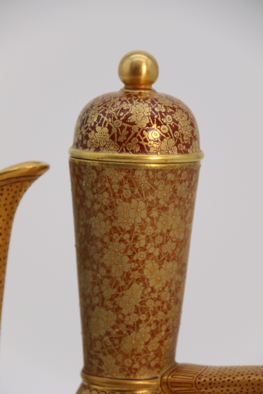 A late 19th-century Doulton Burslem ceramic ewer featuring hand-painted pink floral motifs, an elongated gilt spout, stippled gold handle, and matching stopper. View XIII