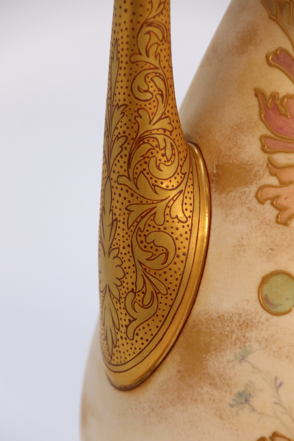 A late 19th-century Doulton Burslem ceramic ewer featuring hand-painted pink floral motifs, an elongated gilt spout, stippled gold handle, and matching stopper. View XV