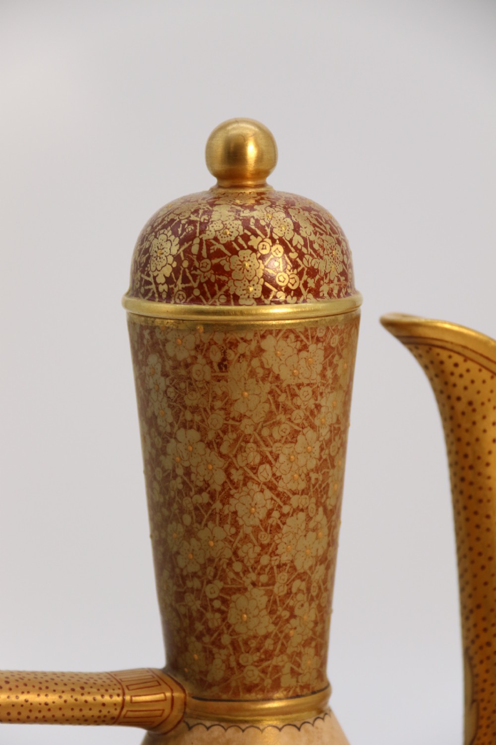 A late 19th-century Doulton Burslem ceramic ewer featuring hand-painted pink floral motifs, an elongated gilt spout, stippled gold handle, and matching stopper. View XVII