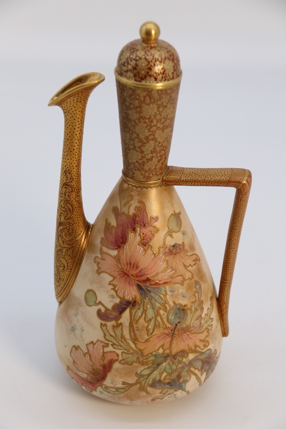A late 19th-century Doulton Burslem ceramic ewer featuring hand-painted pink floral motifs, an elongated gilt spout, stippled gold handle, and matching stopper. View XXI