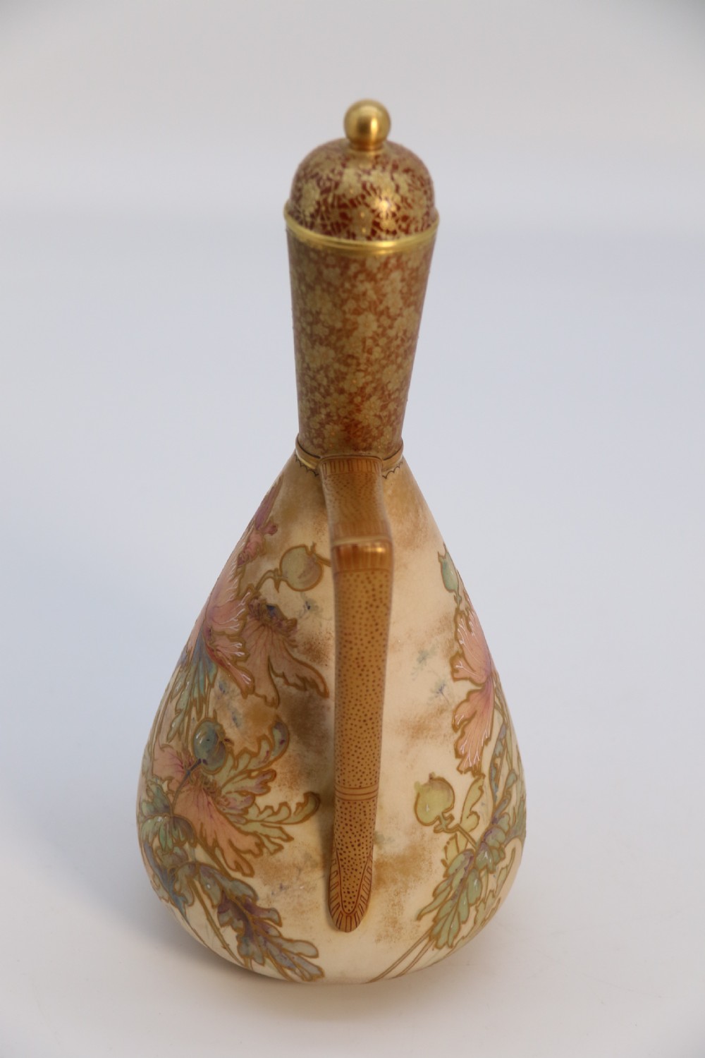 A late 19th-century Doulton Burslem ceramic ewer featuring hand-painted pink floral motifs, an elongated gilt spout, stippled gold handle, and matching stopper. View XXV