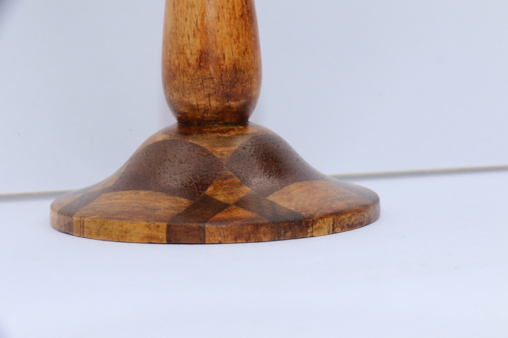 A turned wooden goblet crafted from contrasting specimen woods with a flared rim, a slender stem, and a round patterned base. View VII