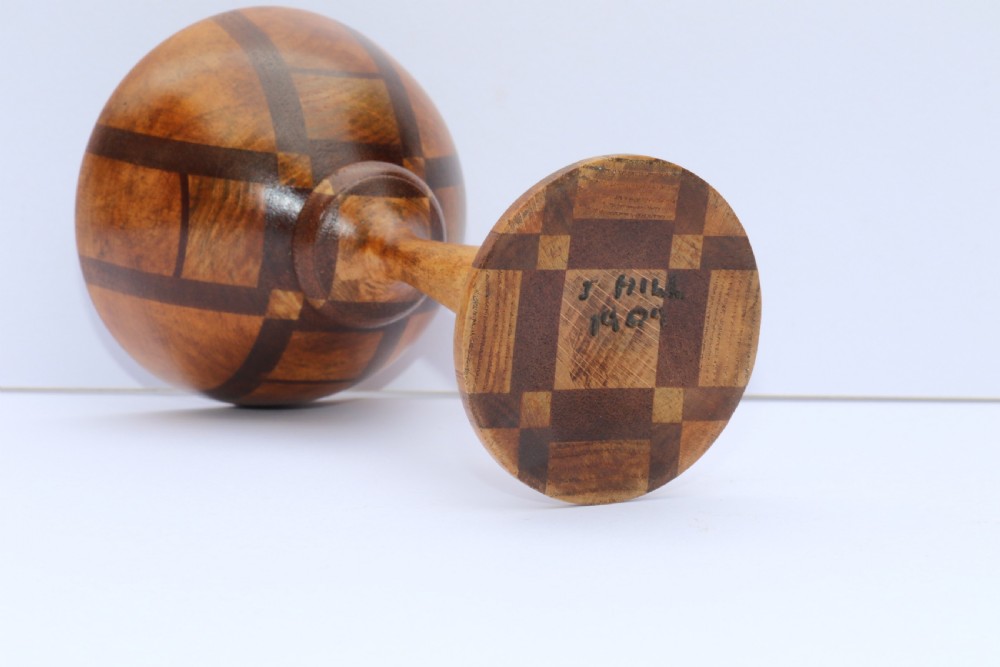 A turned wooden goblet crafted from contrasting specimen woods with a flared rim, a slender stem, and a round patterned base. View XI