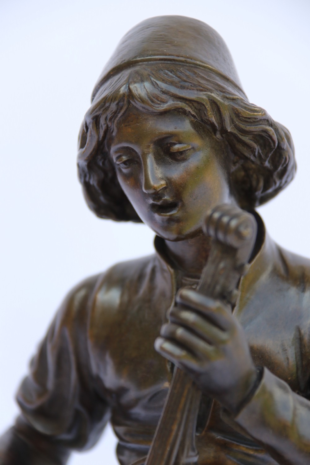  19th century French bronze study of a seated musician playing an early string instrument
 View IX