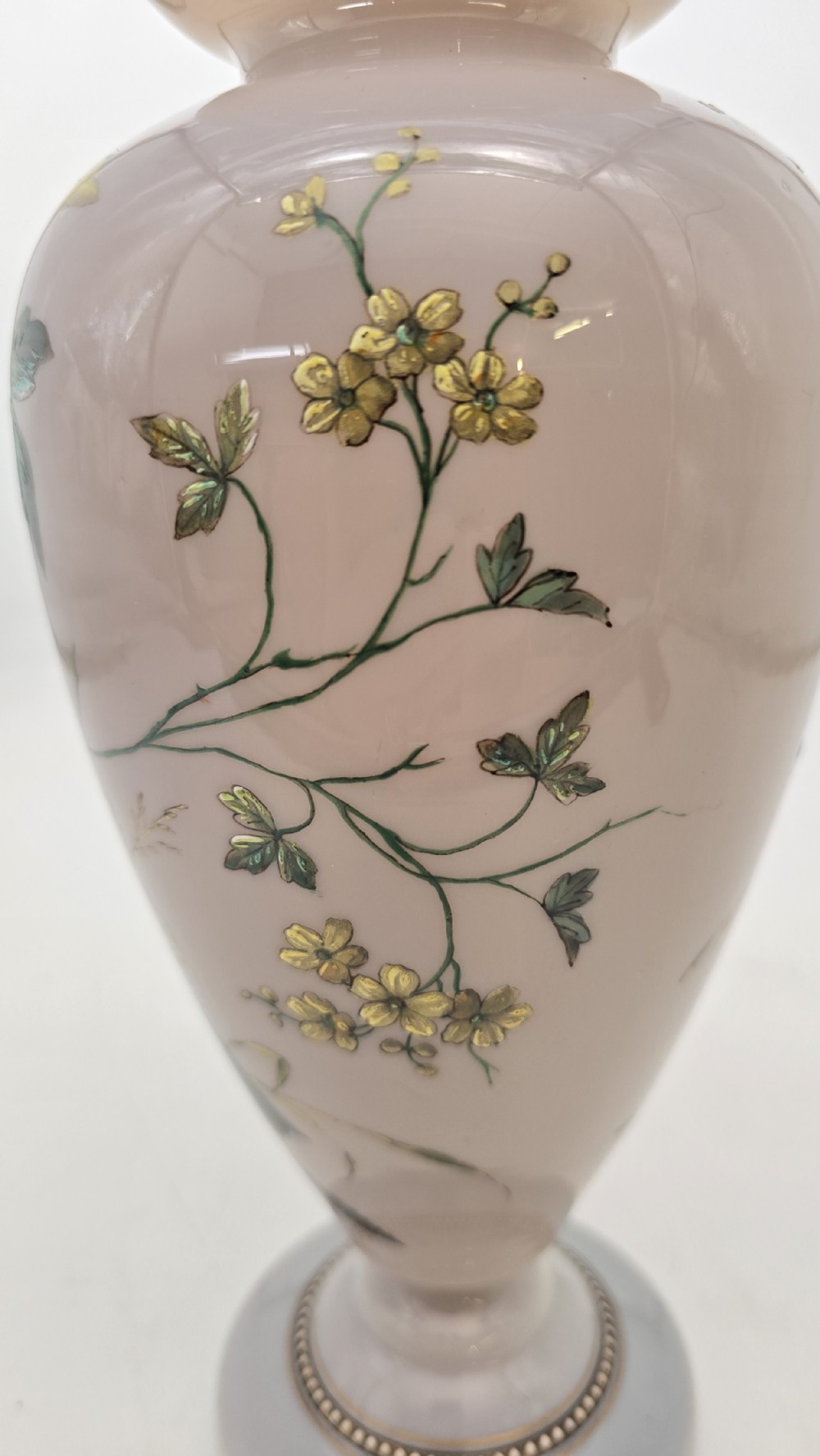 A Victorian opalescent blush pink glass urn vase decorated with hand-painted enamel illustrations of a songbird, delicate blossoms, and gilt trim along the flared rim and base. View XVI