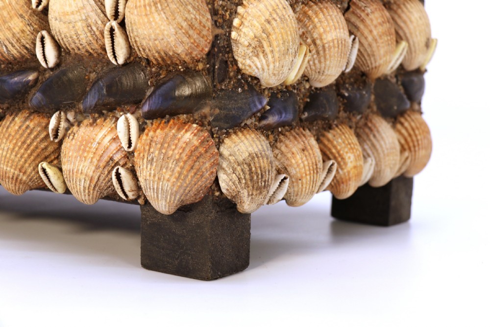 A rectangular folk art box raised on four small feet, fully encrusted with an intricate mosaic of natural sea shells including cockles, cowries, and mussels. View XXIII