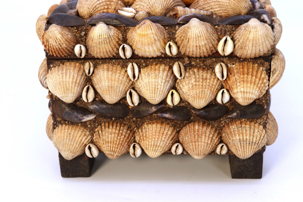 A rectangular folk art box raised on four small feet, fully encrusted with an intricate mosaic of natural sea shells including cockles, cowries, and mussels. View XXV