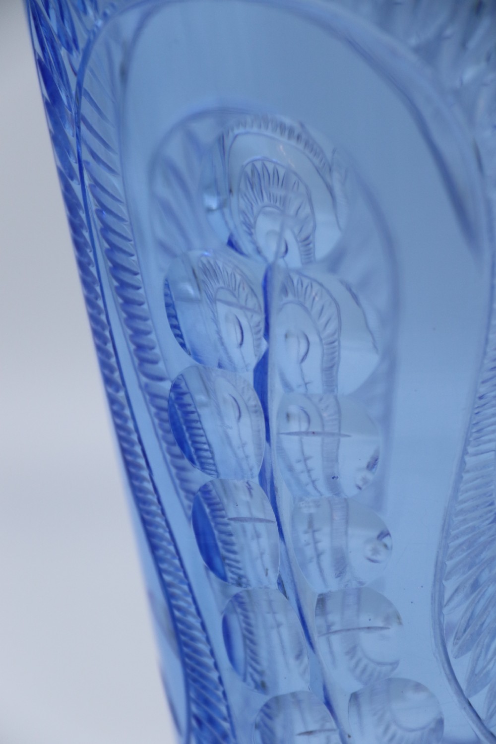 A flared Art Deco sapphire blue cut glass vase featuring geometric carved details on a faceted bulbous pedestal base. View V