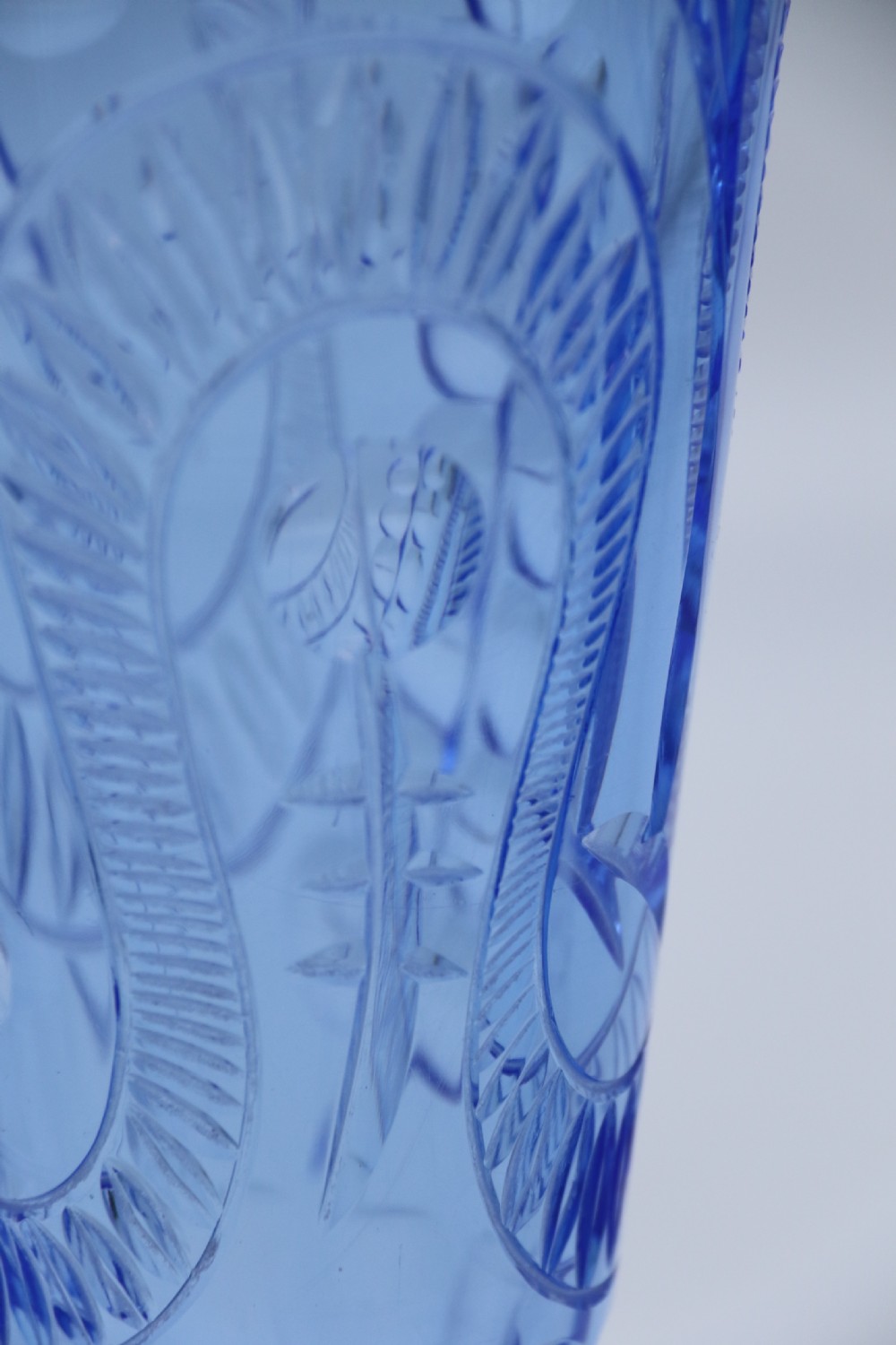 A flared Art Deco sapphire blue cut glass vase featuring geometric carved details on a faceted bulbous pedestal base. View XI