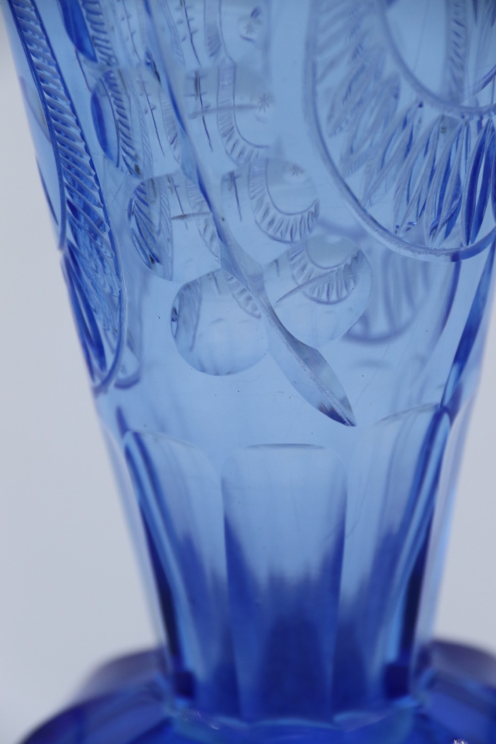 A flared Art Deco sapphire blue cut glass vase featuring geometric carved details on a faceted bulbous pedestal base. View XIII