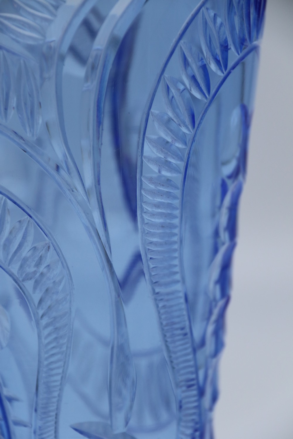 A flared Art Deco sapphire blue cut glass vase featuring geometric carved details on a faceted bulbous pedestal base. View XV