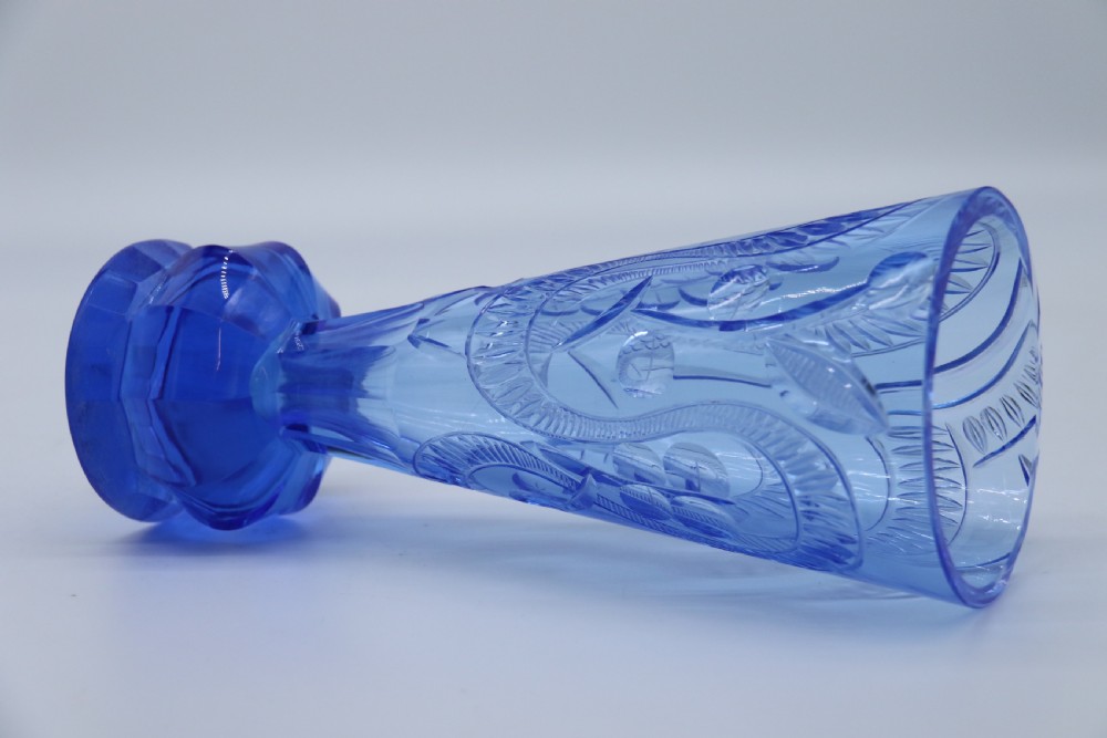 A flared Art Deco sapphire blue cut glass vase featuring geometric carved details on a faceted bulbous pedestal base. View XVII