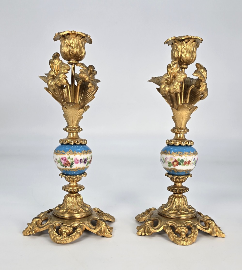 A pair of French 19th C ormolu and porcelain candlesticks.