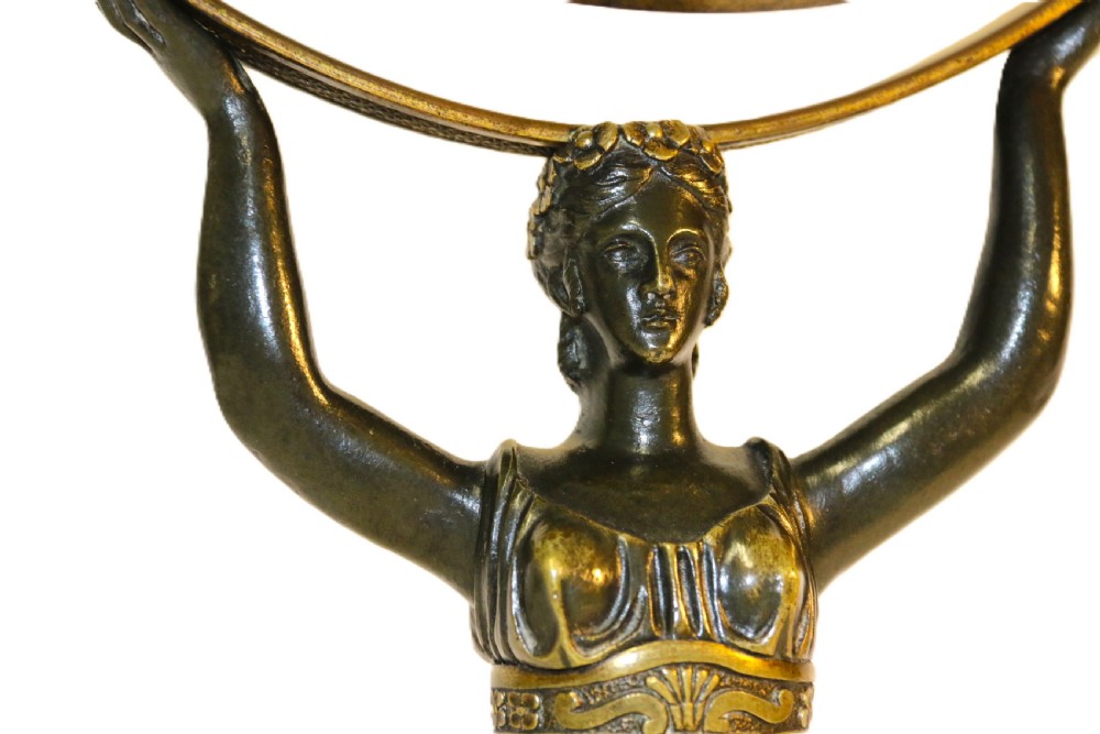 A French Empire period pedestal mirror featuring a patinated bronze classical female caryatid holding a circular tilting mirror with a gilt bronze bezel and base. View VIII