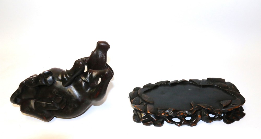 A pair of late Qing dynasty hand-carved dark hardwood water buffaloes, each mounted on a pierced wooden base and depicting a small boy resting on its back. View XI