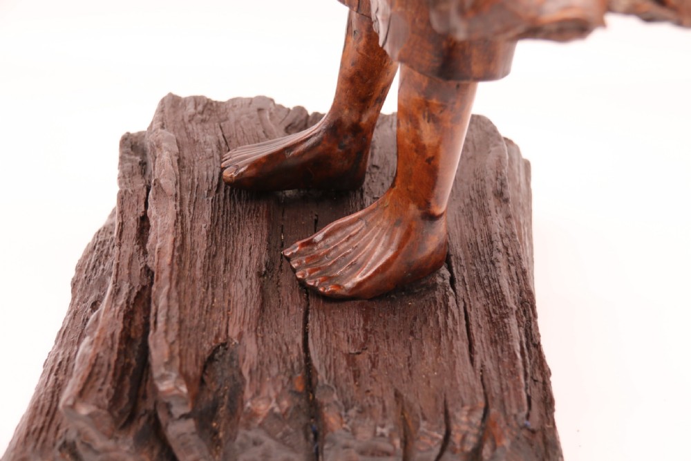 A late 19th-century Chinese carved burr root wood figure depicting a bearded scholar holding a staff, set upon a carved wood base. View XVIII