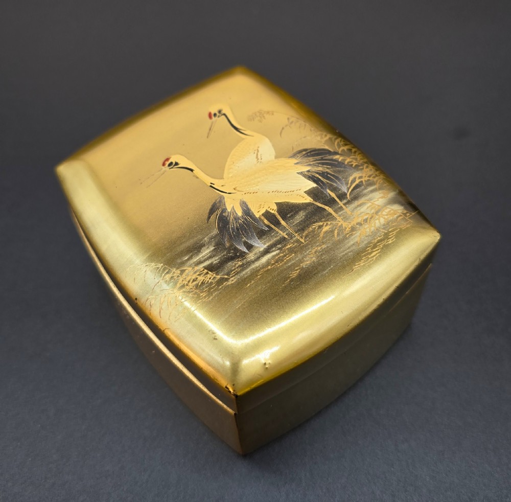A Japanese Meiji period gold lacquered box decorated with Cranes