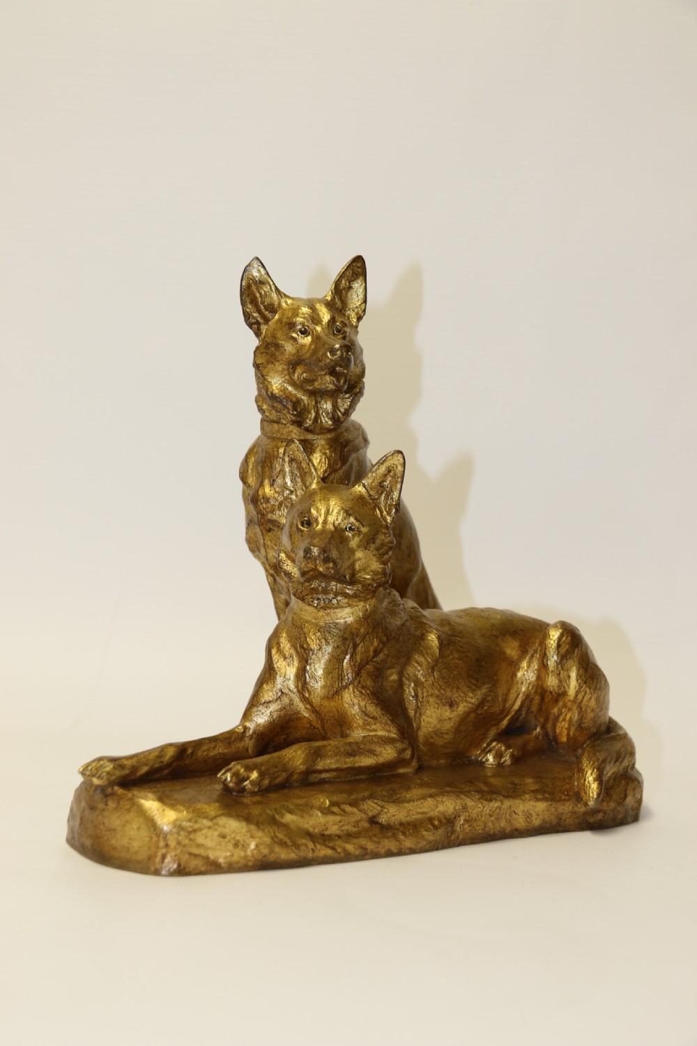 A French gilt bronze sculpture depicting two German Shepherd dogs on a naturalistic integrated base, one resting lying down and one sitting upright behind. View III