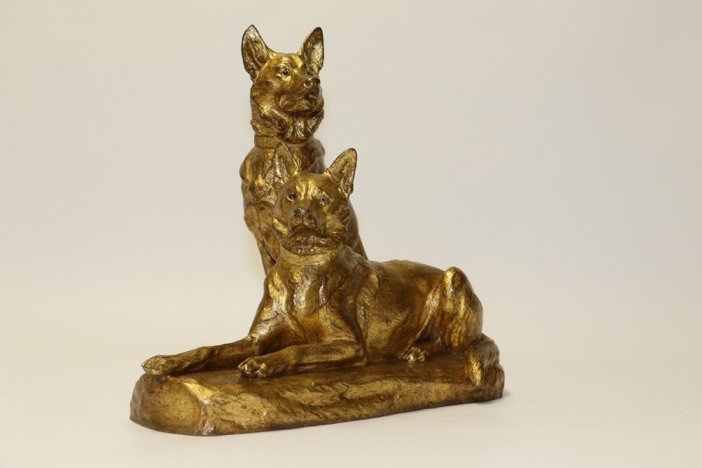 A French gilt bronze sculpture depicting two German Shepherd dogs on a naturalistic integrated base, one resting lying down and one sitting upright behind. View VII