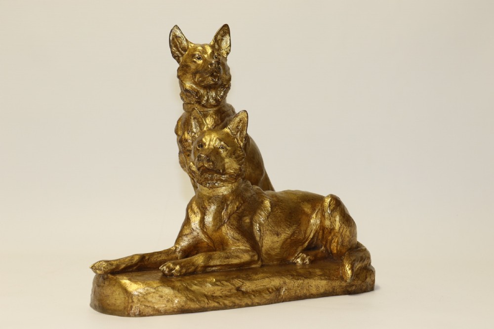 A French gilt bronze sculpture depicting two German Shepherd dogs on a naturalistic integrated base, one resting lying down and one sitting upright behind. View XI