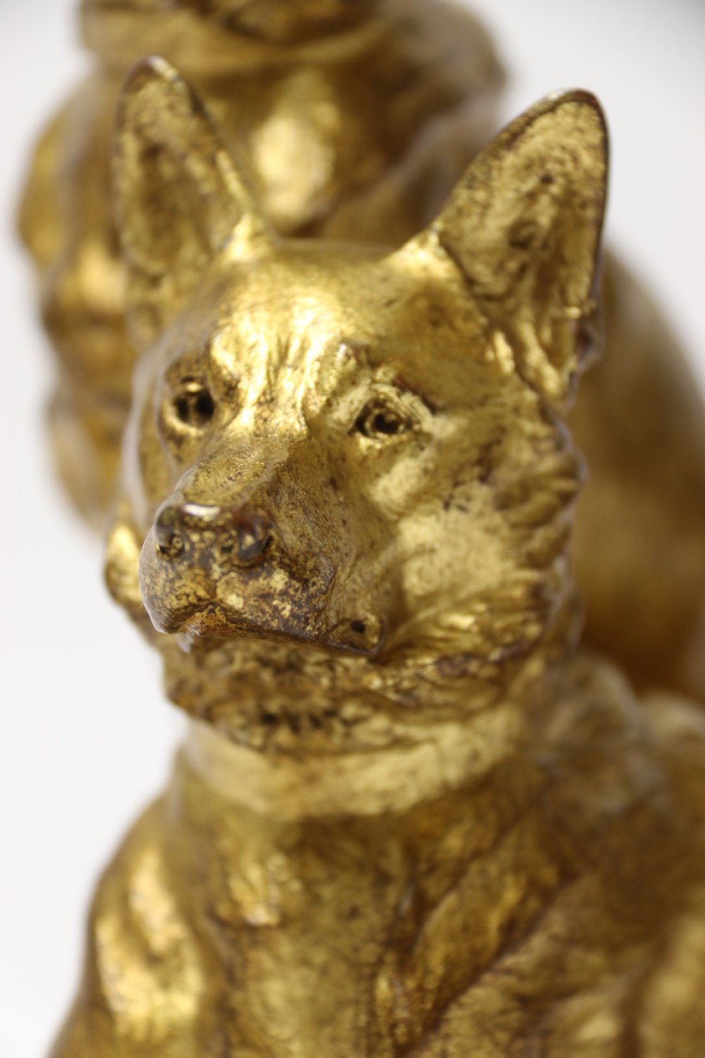 A French gilt bronze sculpture depicting two German Shepherd dogs on a naturalistic integrated base, one resting lying down and one sitting upright behind. View XII