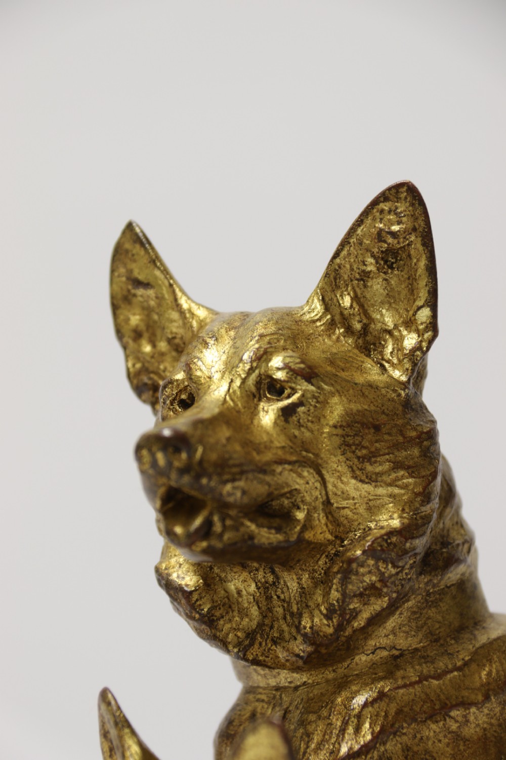 A French gilt bronze sculpture depicting two German Shepherd dogs on a naturalistic integrated base, one resting lying down and one sitting upright behind. View XIII
