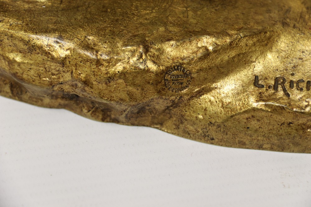 A French gilt bronze sculpture depicting two German Shepherd dogs on a naturalistic integrated base, one resting lying down and one sitting upright behind. View XV