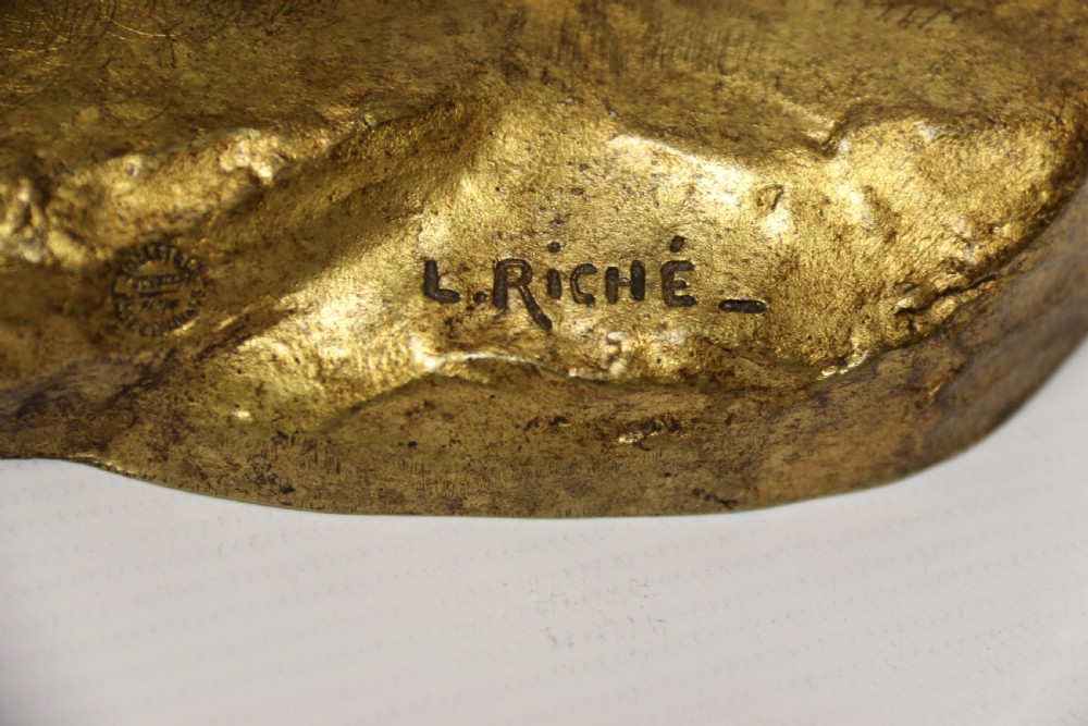 A French gilt bronze sculpture depicting two German Shepherd dogs on a naturalistic integrated base, one resting lying down and one sitting upright behind. View XVI