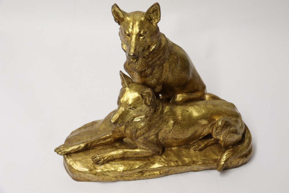 A French gilt bronze sculpture depicting two German Shepherd dogs on a naturalistic integrated base, one resting lying down and one sitting upright behind. View XVIII