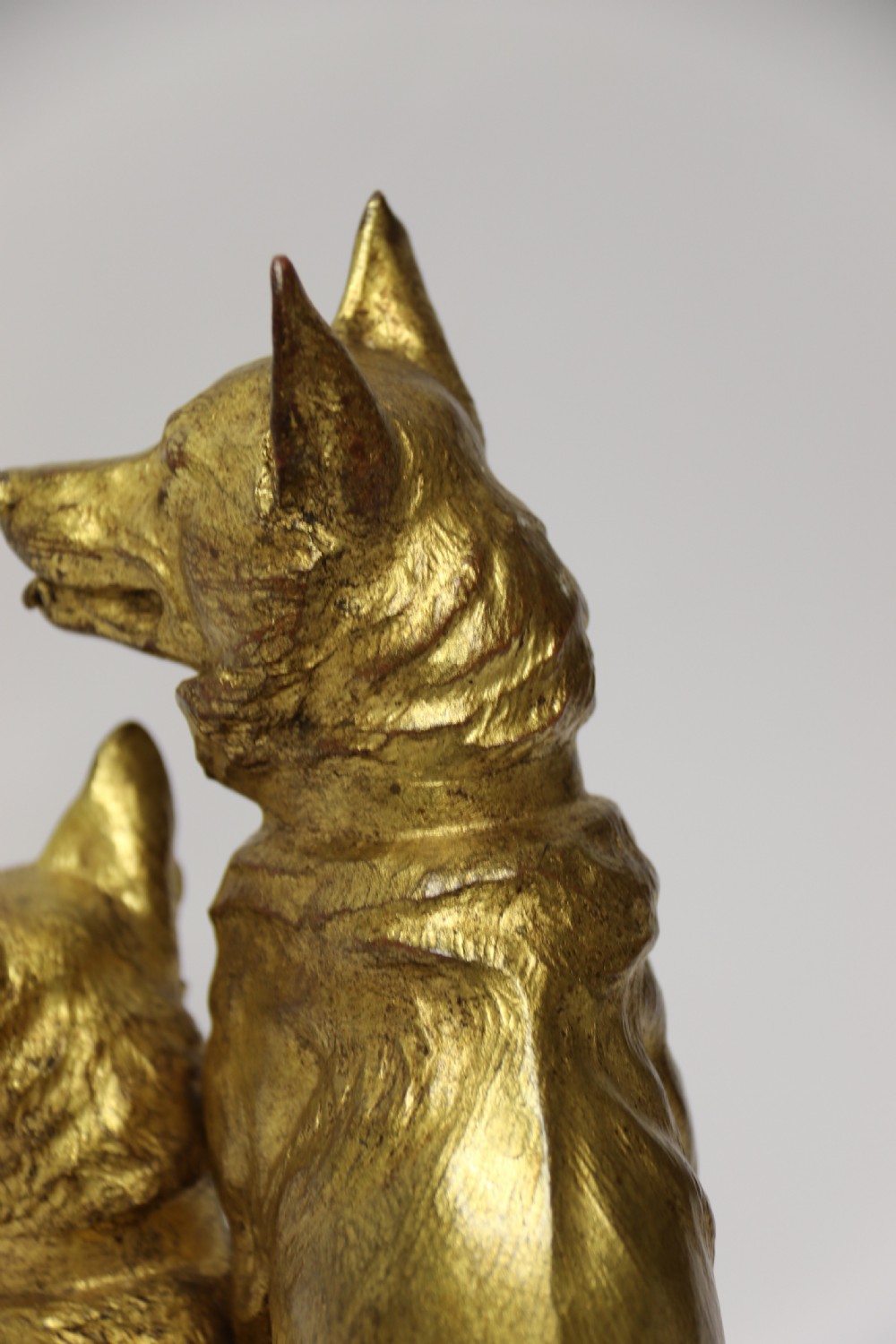 A French gilt bronze sculpture depicting two German Shepherd dogs on a naturalistic integrated base, one resting lying down and one sitting upright behind. View XXI