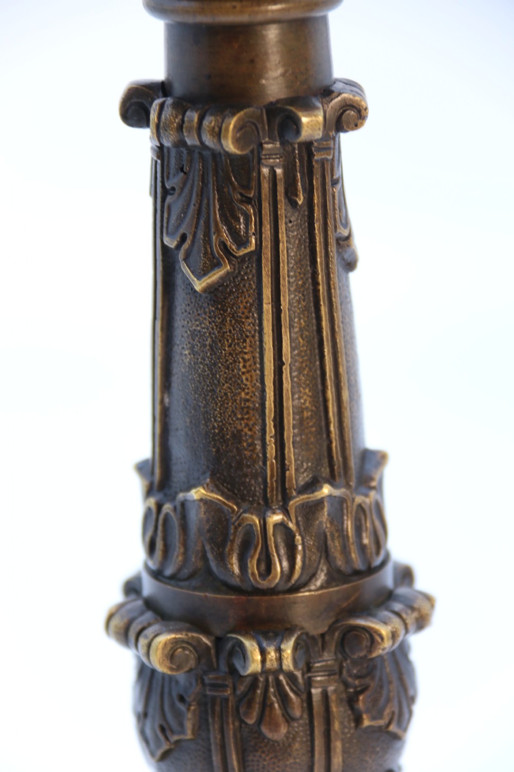 A pair of antique French Empire dark bronze candlesticks with ornate floral carvings and claw feet, resting upon yellow sienna marble plinths. View XXI