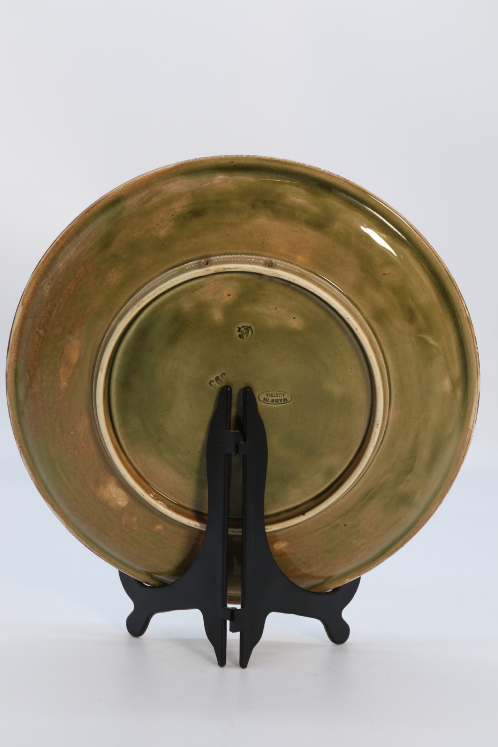 A circular late nineteenth-century Austrian majolica decorative plate featuring relief mouldings of birds perched on branches beside sunflowers over a teal glazed background. View VII