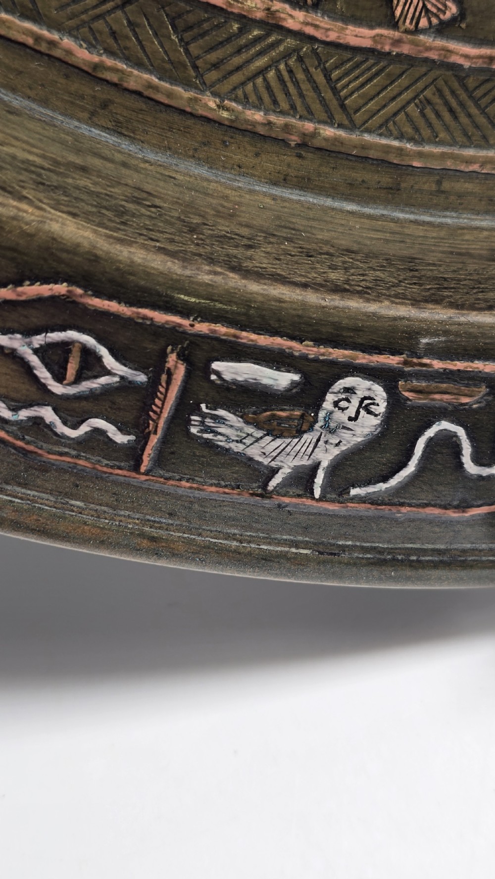 A circular bronze charger plate inlaid with silver and copper depicting ancient Egyptian figures, winged scarabs, and hieroglyphic motifs. View XI