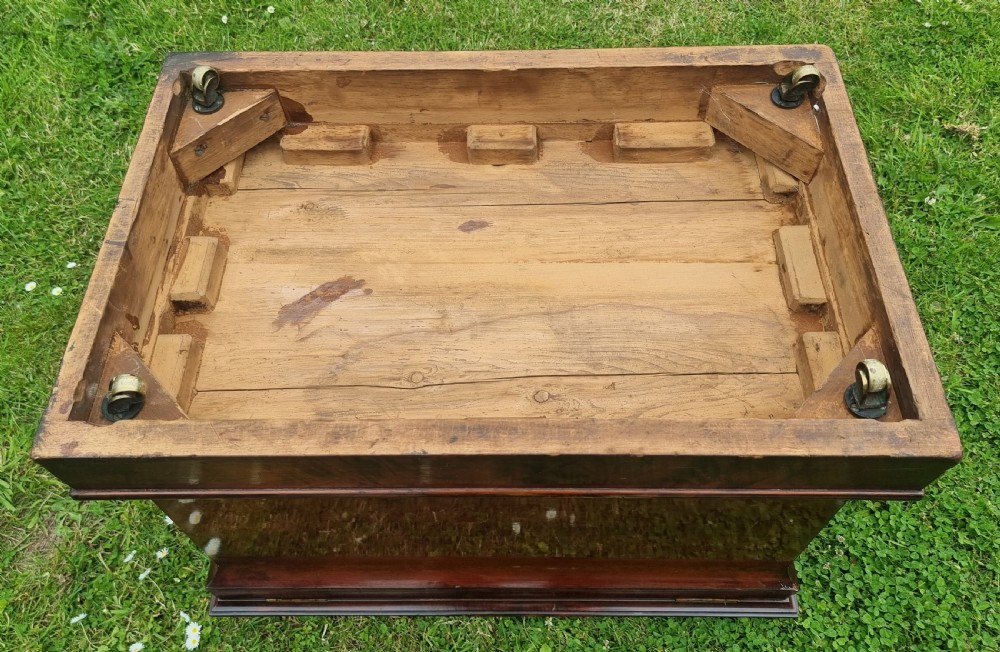 A Regency period sarcophagus-shaped wine cooler crafted from flame mahogany veneer with a stepped pediment lid and plinth base. View XVI