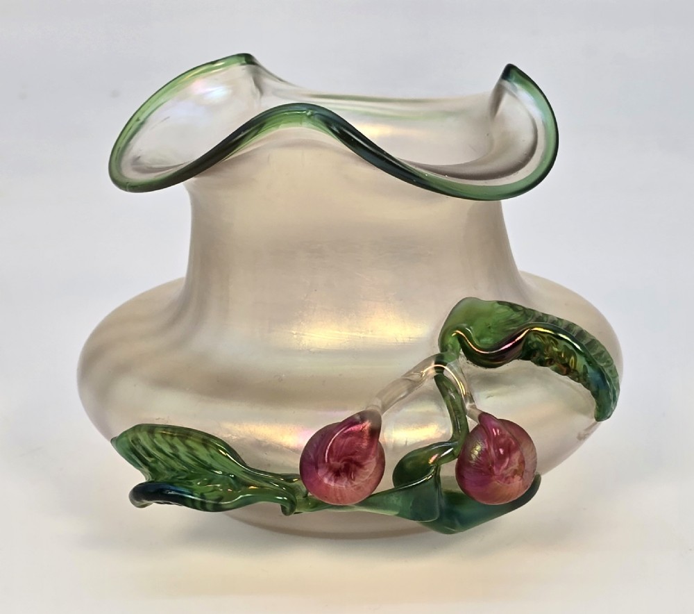 An Art Nouveau iridescent glass vase featuring a wavy green-rimmed mouth and hand-applied glass cherries with green leaves on the side. View III