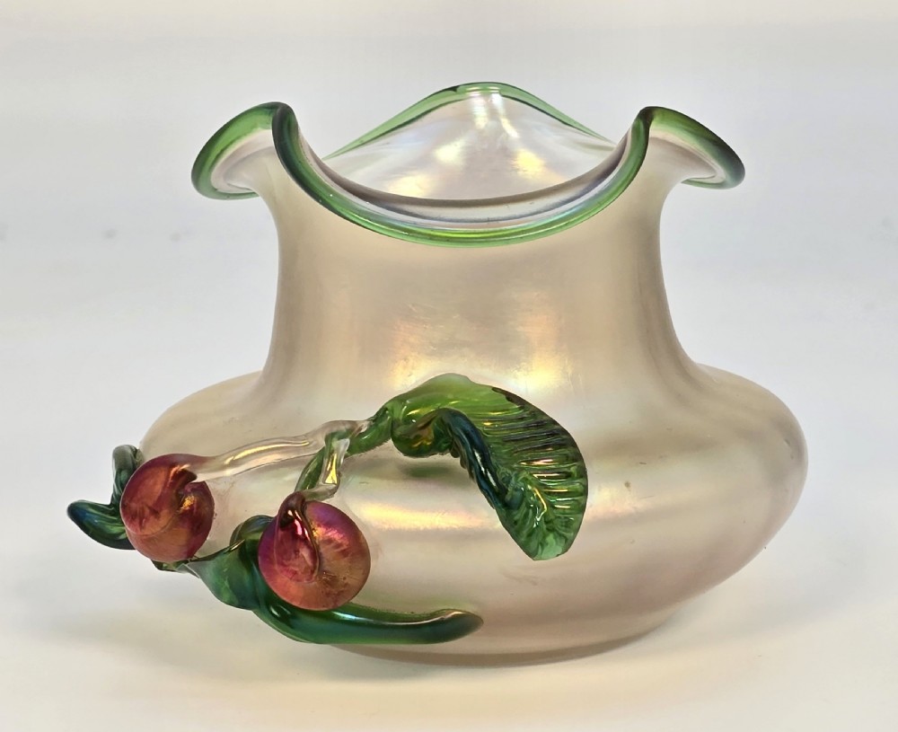 An Art Nouveau iridescent glass vase featuring a wavy green-rimmed mouth and hand-applied glass cherries with green leaves on the side. View IV