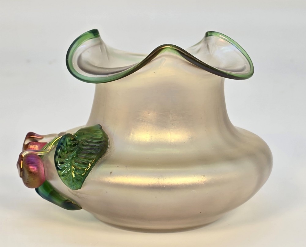 An Art Nouveau iridescent glass vase featuring a wavy green-rimmed mouth and hand-applied glass cherries with green leaves on the side. View V
