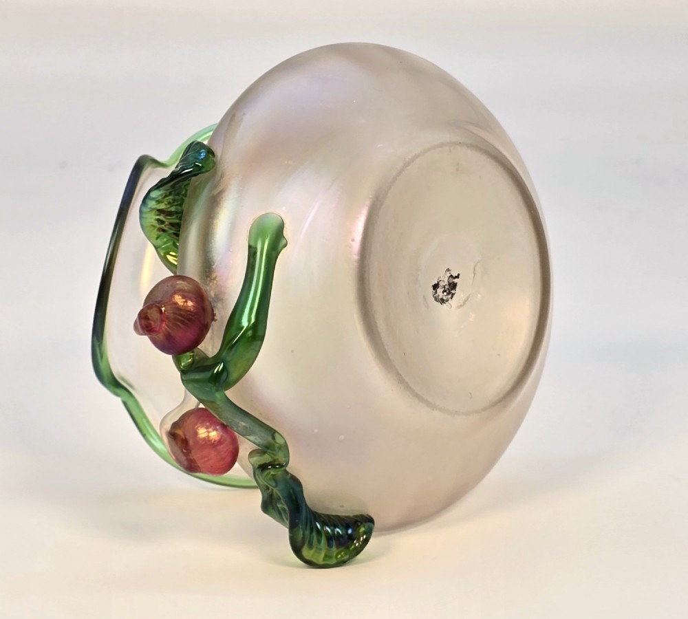 An Art Nouveau iridescent glass vase featuring a wavy green-rimmed mouth and hand-applied glass cherries with green leaves on the side. View X