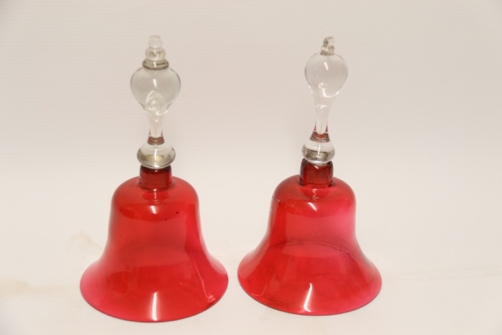 A pair of Victorian hand bells crafted from ruby red glass with clear glass baluster handles. View III